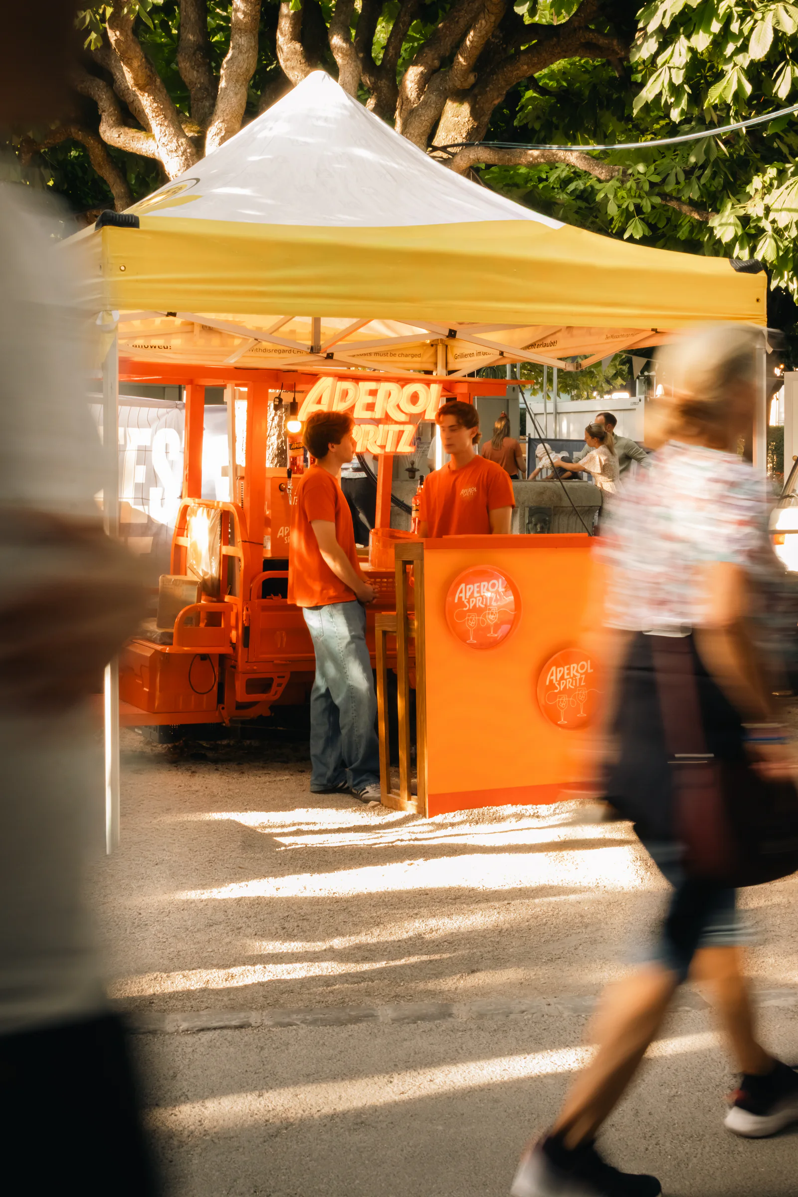 The Aperol stand in the afternoon, guests passing