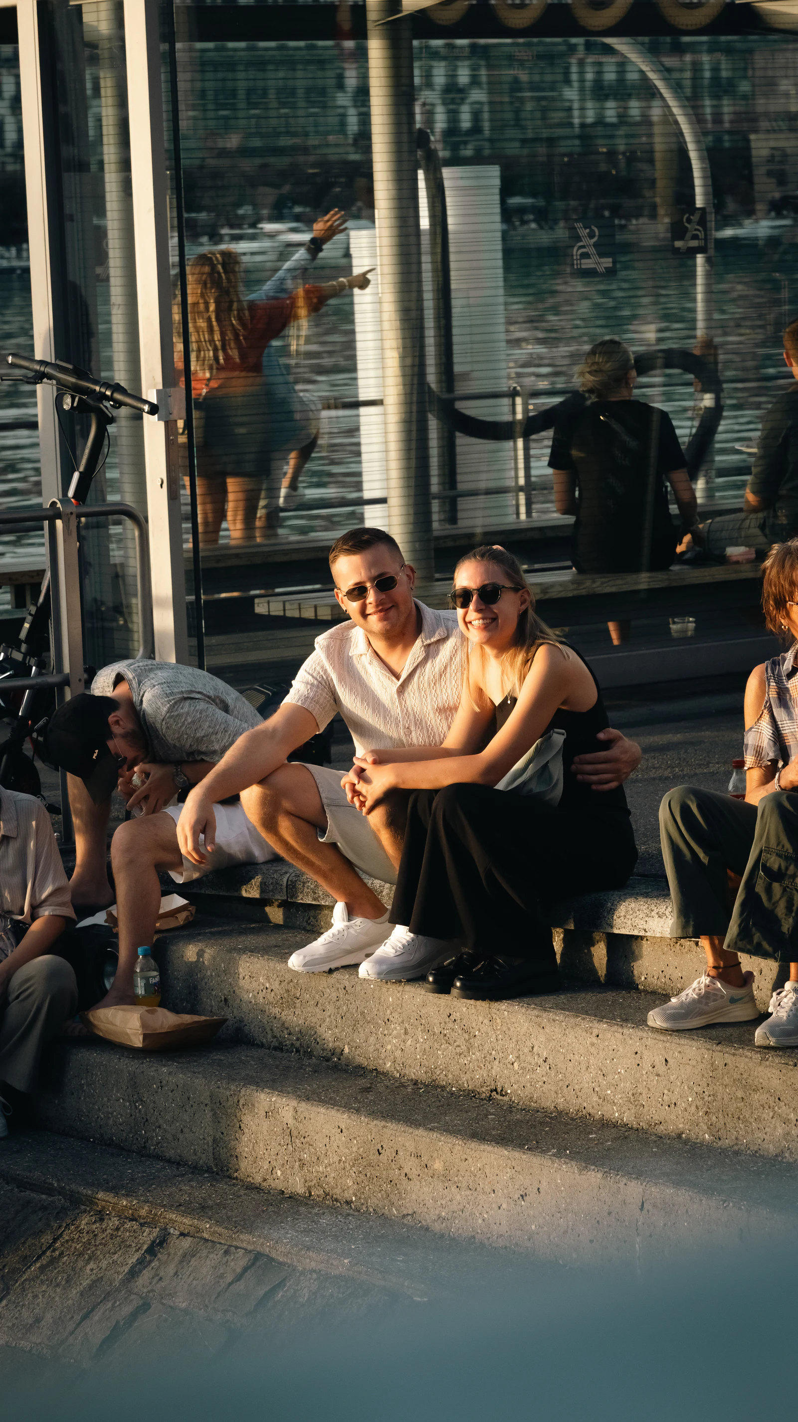 Guests on the steps in the afternoon sun