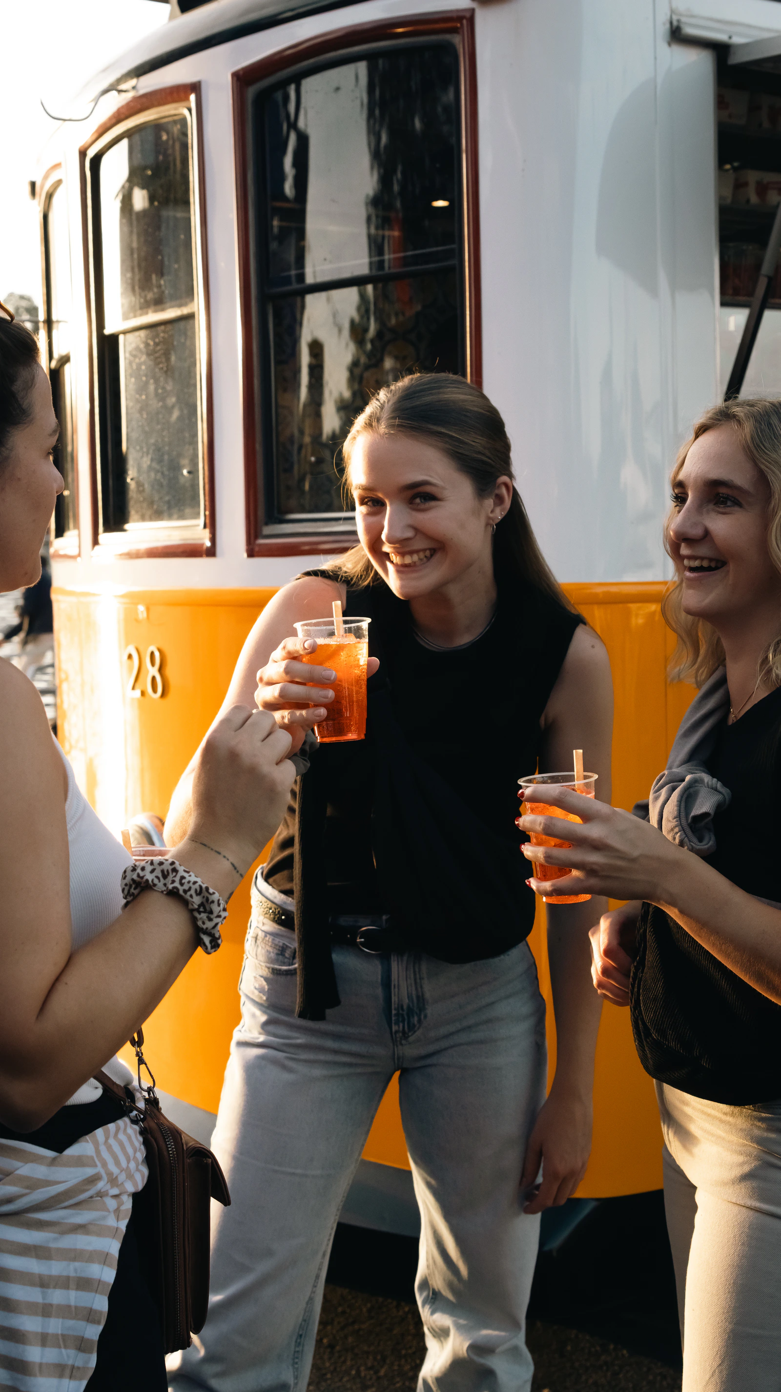 Guests with spritzes beside the tram bar