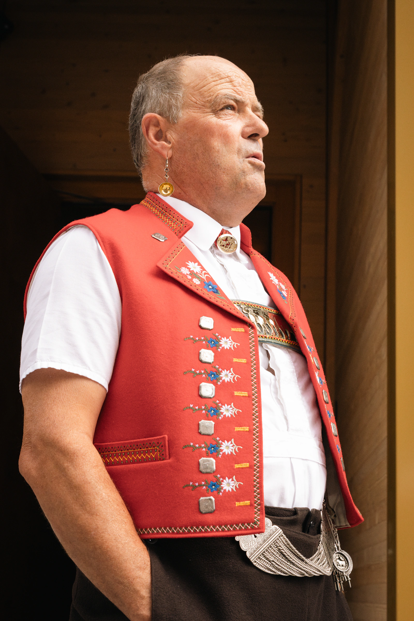 A man in traditional Appenzell dress standing in a doorway