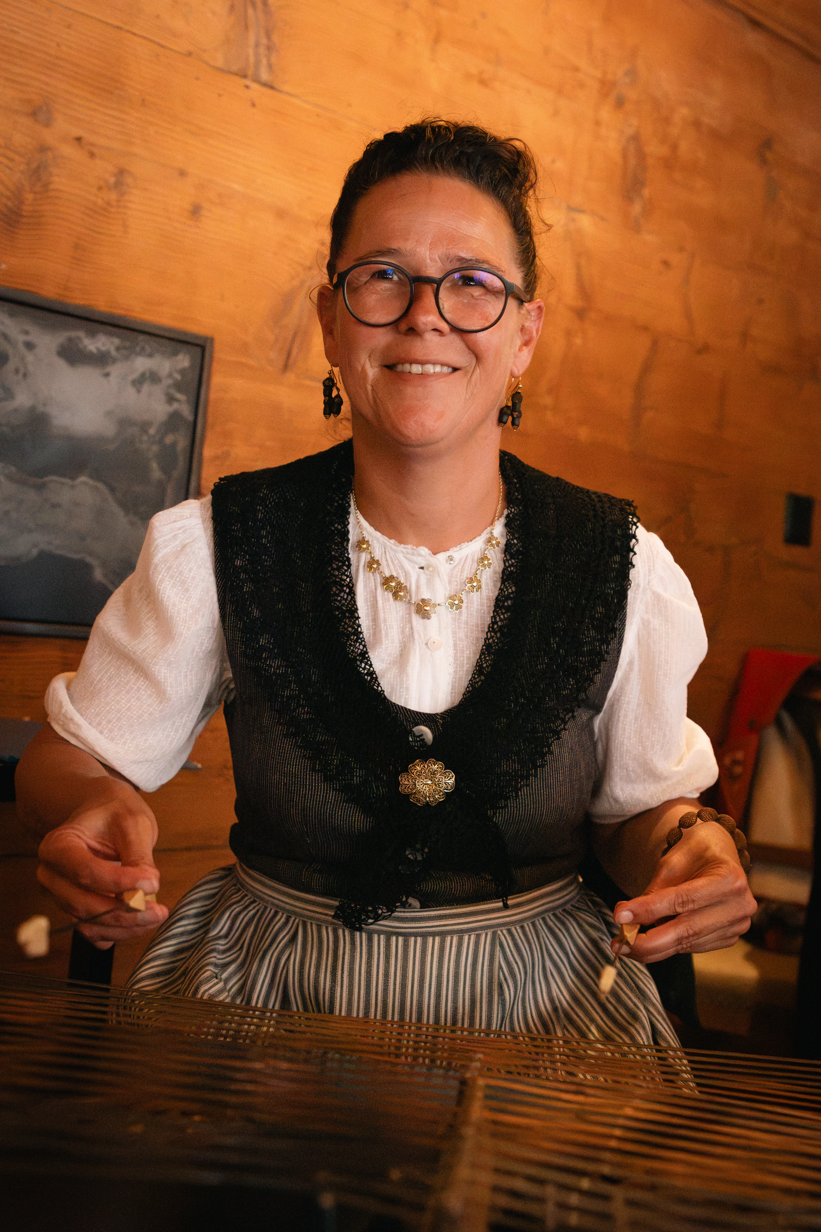 A woman in traditional Appenzell dress behind the counter
