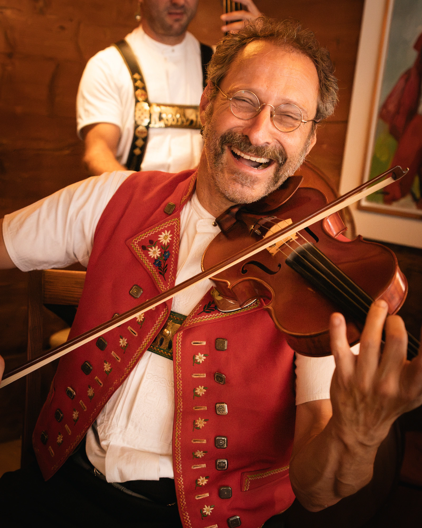 A fiddler in an Appenzell waistcoat, mid-tune