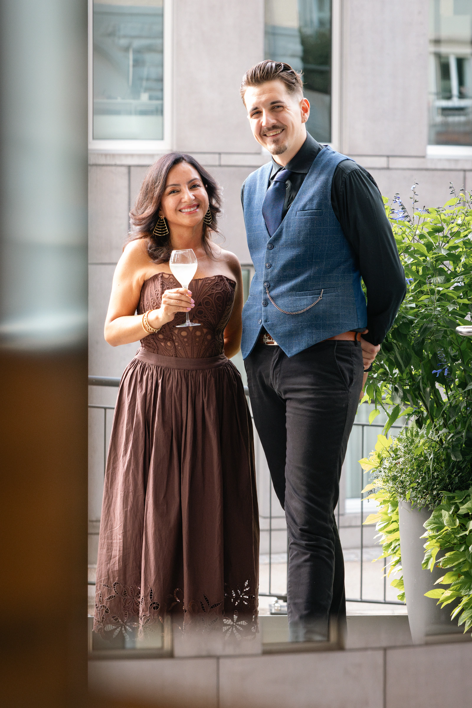 A couple at the entrance with glasses in hand