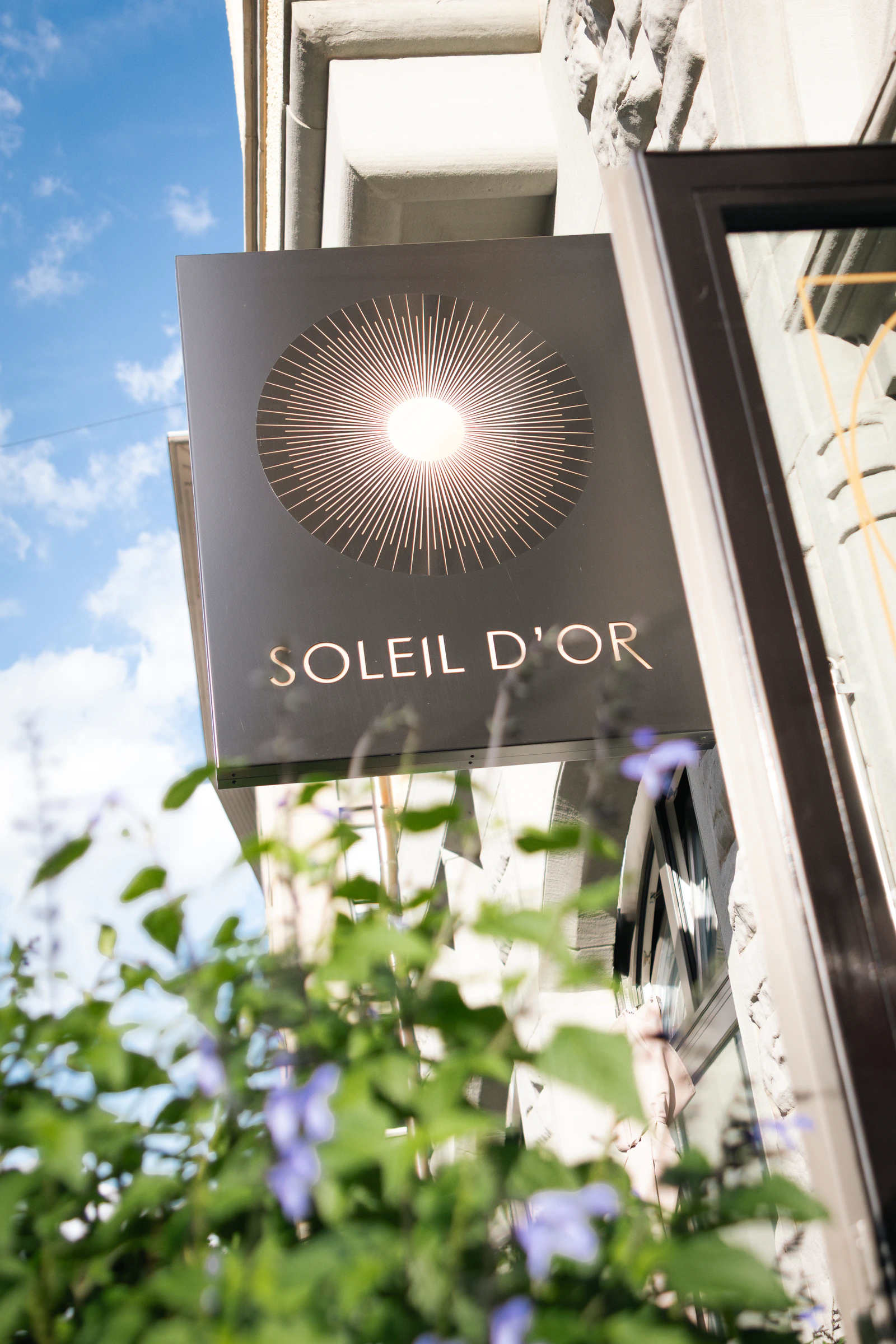 The Soleil d'Or sign above the street