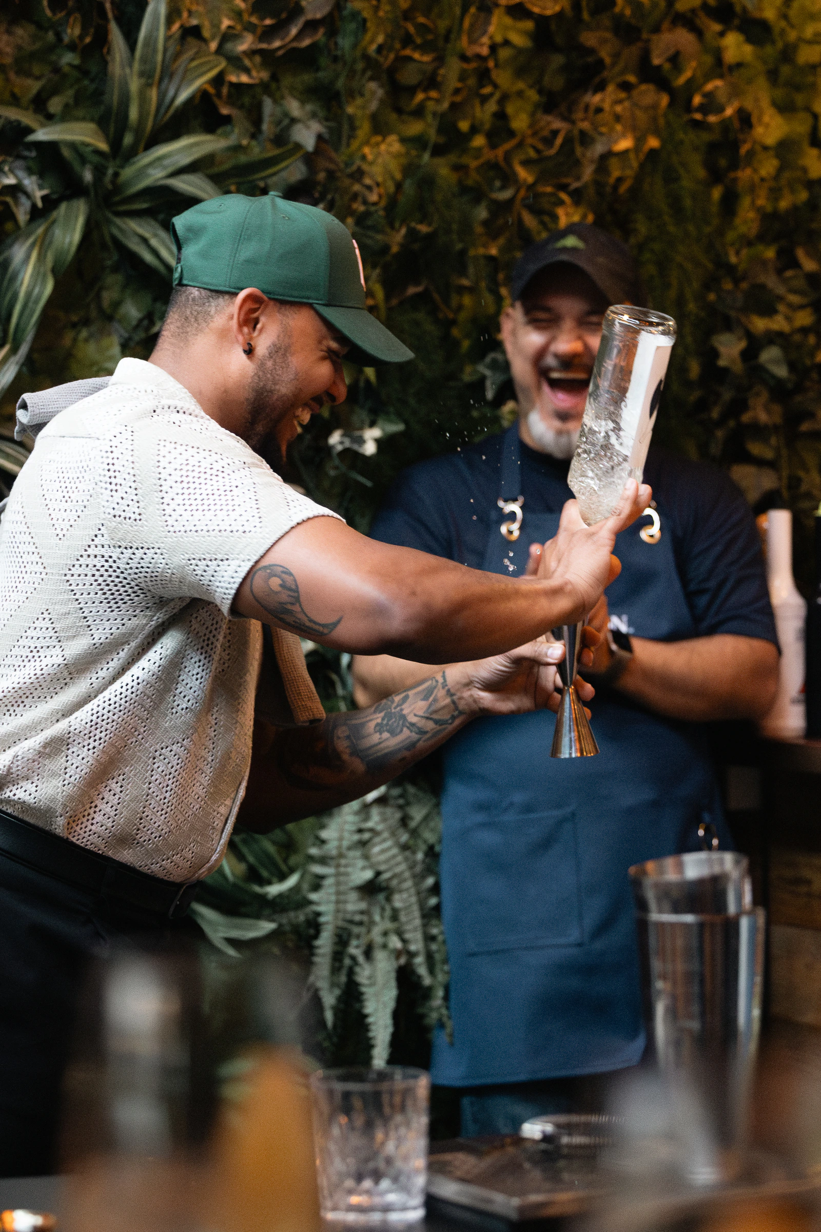 Two bartenders working the bar together