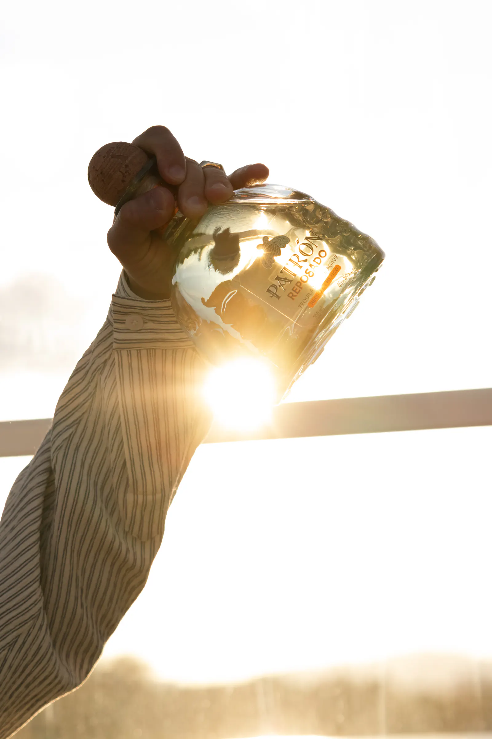 A bottle poured against the setting sun