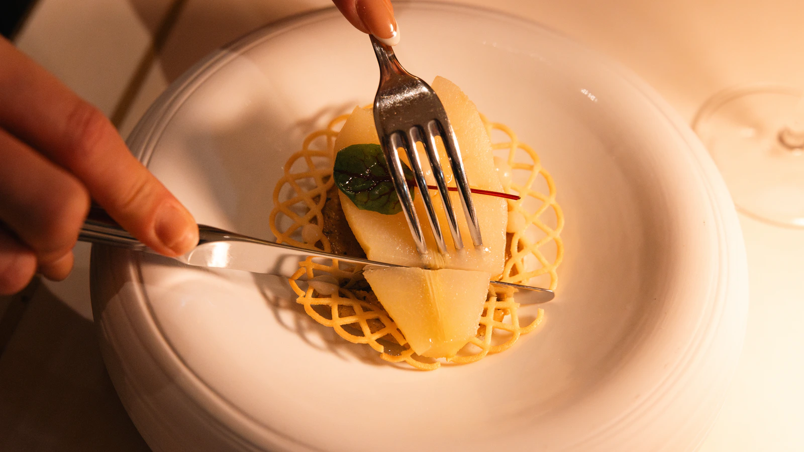 A dessert lifted from the plate on a fork, shot close